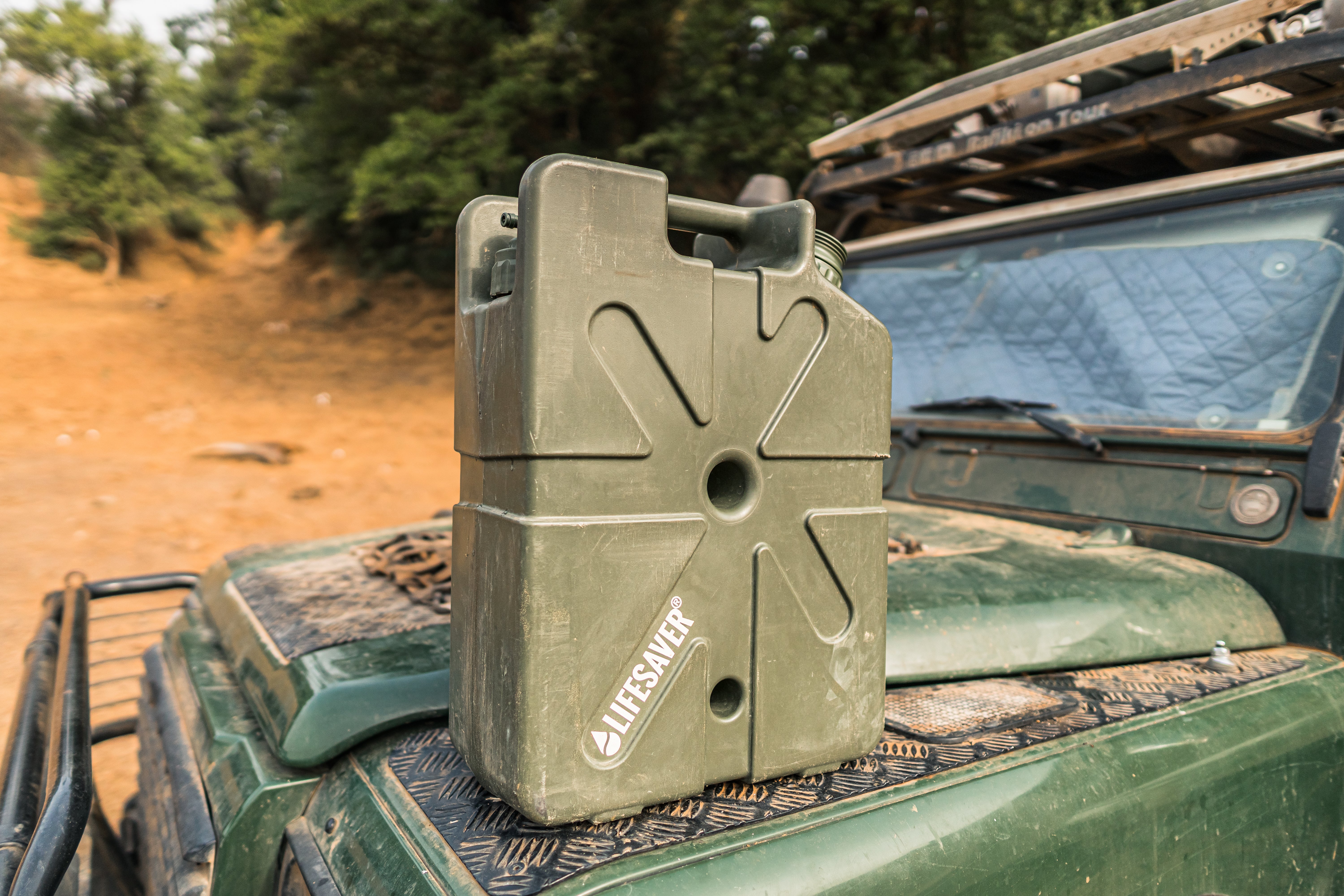 Green Jerrycan on a 4 x 4 overlanding vehicle in an outdoor setting