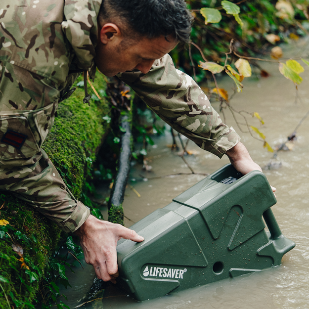 Load image into Gallery viewer, Person in camouflage holding a green 'Lifesaver' Jerrycan in water
