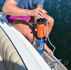 Person using a Liberty water filter on a boat with water in the background