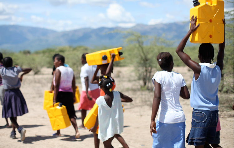 African villagers walking to a river to fill their LifeSaver Jerrycans